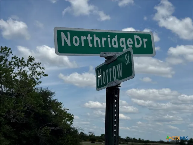 a street sign on a pole on a street