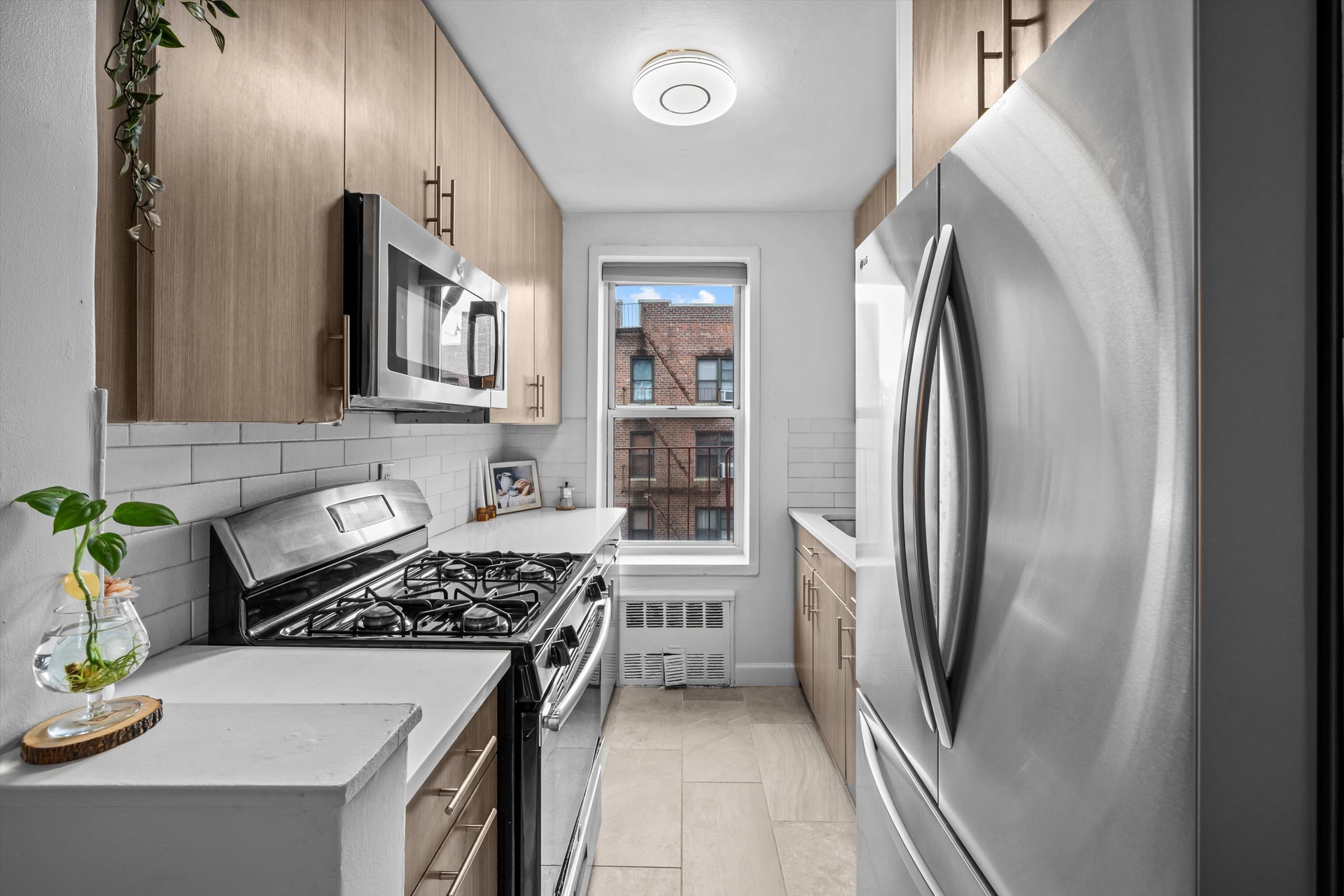 3520 Tryon Avenue, Unit 603 Bronx, NY 10467 - Photo 7 of 15 a kitchen with stainless steel appliances granite countertop a refrigerator and a stove