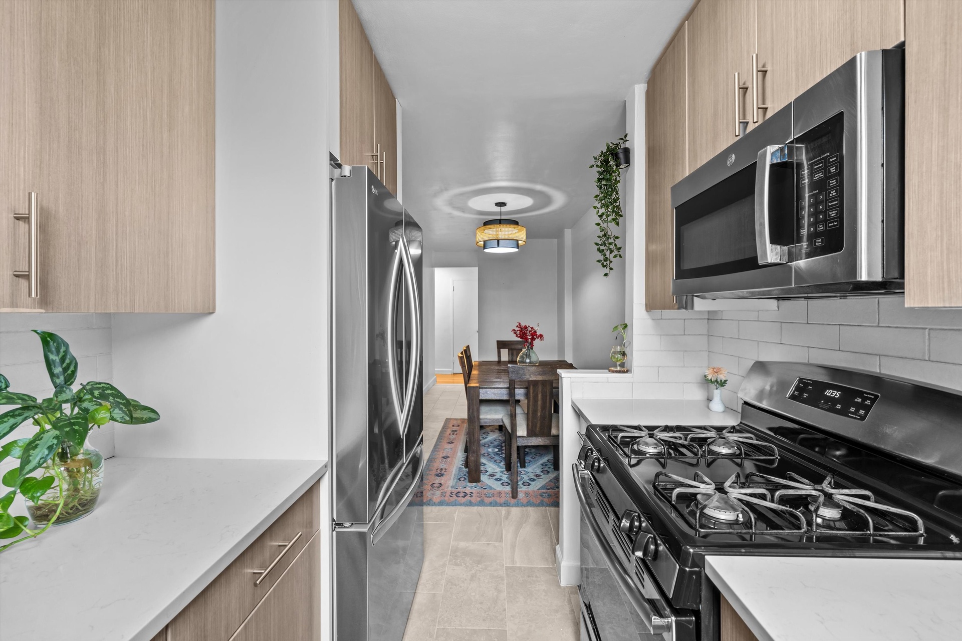 3520 Tryon Avenue, Unit 603 Bronx, NY 10467 - Photo 8 of 15 a kitchen with stainless steel appliances a stove a microwave and a sink