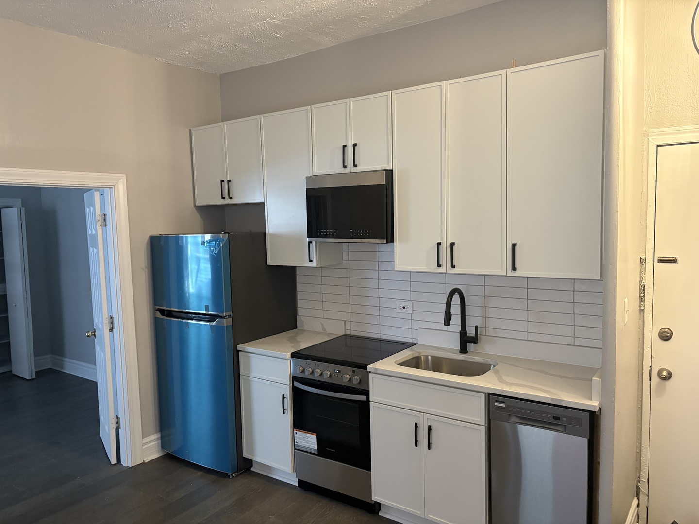 20 East Goethe Street, Unit 404 Chicago, IL 60610 - Photo 4 of 8 a kitchen with stainless steel appliances a refrigerator sink and microwave