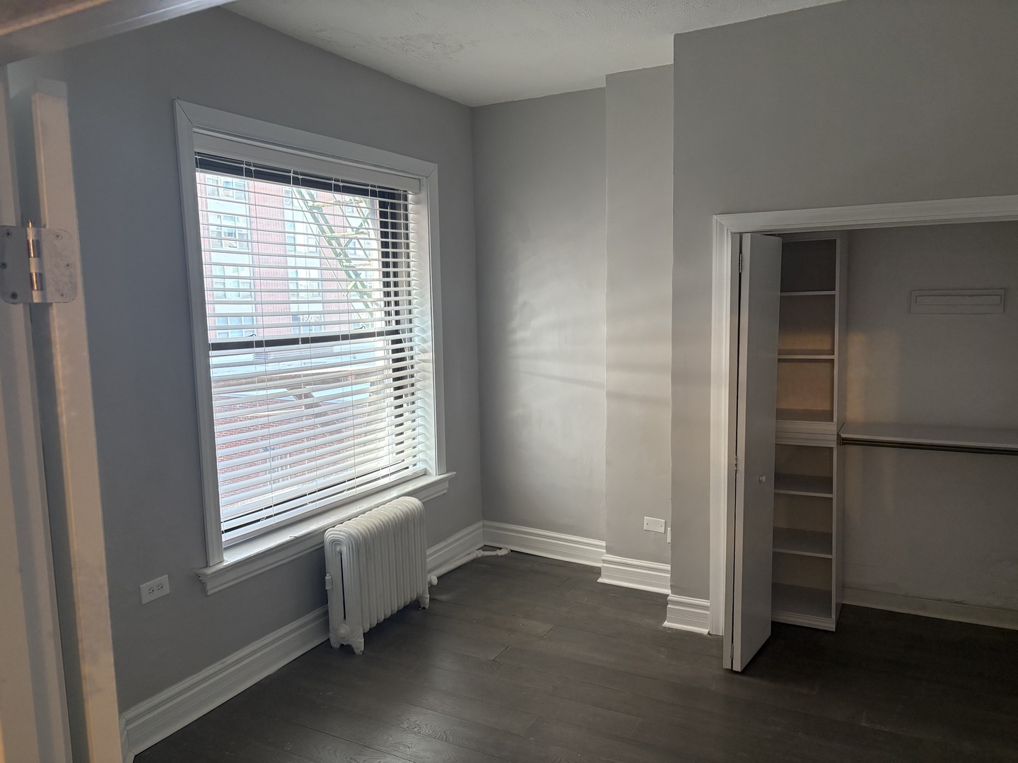 20 East Goethe Street, Unit 404 Chicago, IL 60610 - Photo 8 of 8 wooden floor and window in an empty room