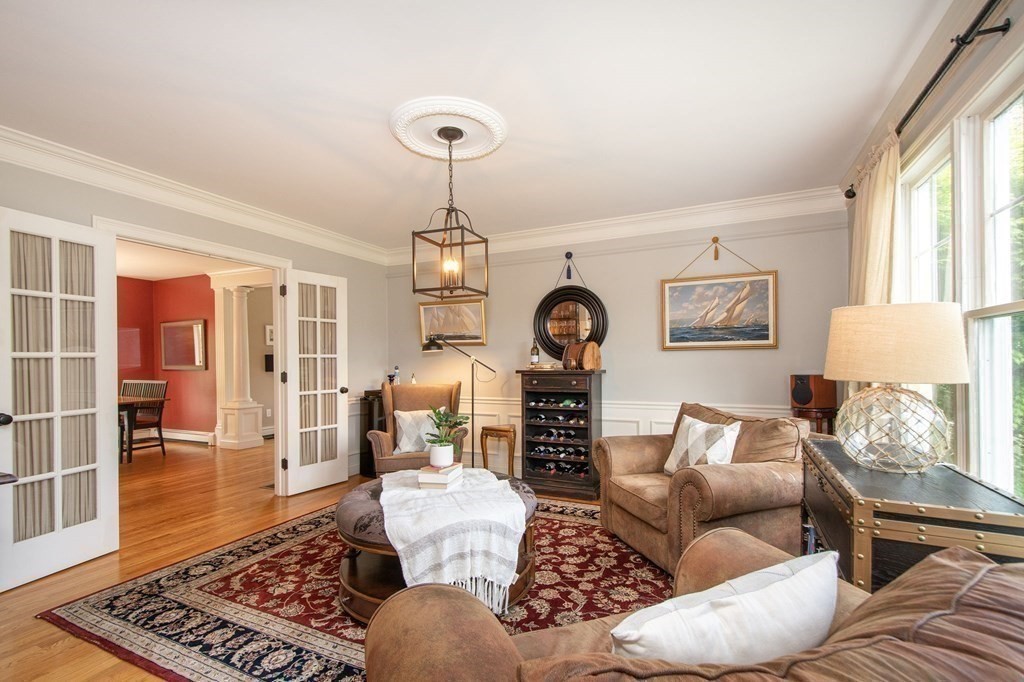 124 Hillcrest Road Marshfield, MA 02050 - Photo 11 of 41 a living room with furniture and a chandelier