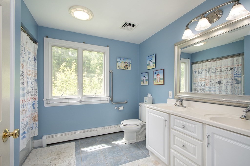 124 Hillcrest Road Marshfield, MA 02050 - Photo 29 of 41 a spacious bathroom with a double vanity sink a large mirror and a toilet