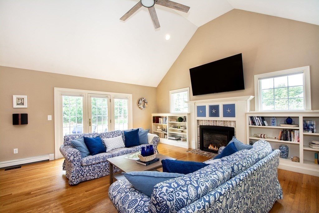 124 Hillcrest Road Marshfield, MA 02050 - Photo 5 of 41 a living room with furniture a flat screen tv and a fireplace