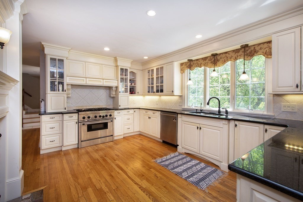 124 Hillcrest Road Marshfield, MA 02050 - Photo 8 of 41 a kitchen with stainless steel appliances kitchen island granite countertop a stove a sink and a refrigerator