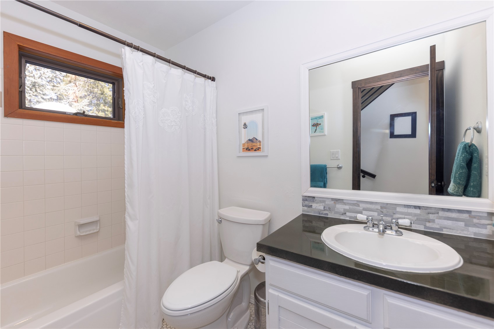 357 Vail Circle Dillon, CO 80435 - Photo 12 of 30 a bathroom with a granite countertop toilet a sink and a mirror