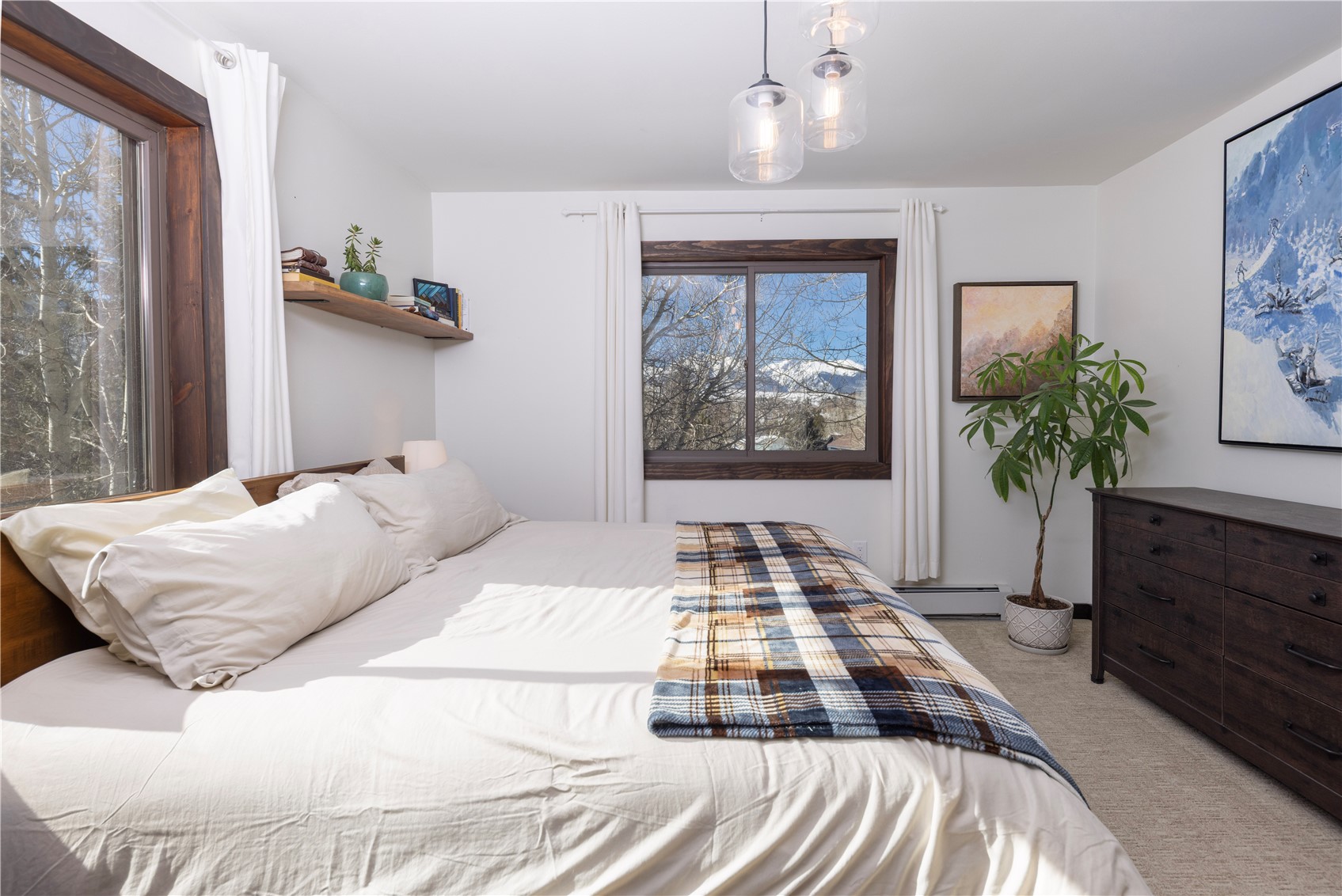 357 Vail Circle Dillon, CO 80435 - Photo 14 of 30 a bedroom with a bed and a potted plant