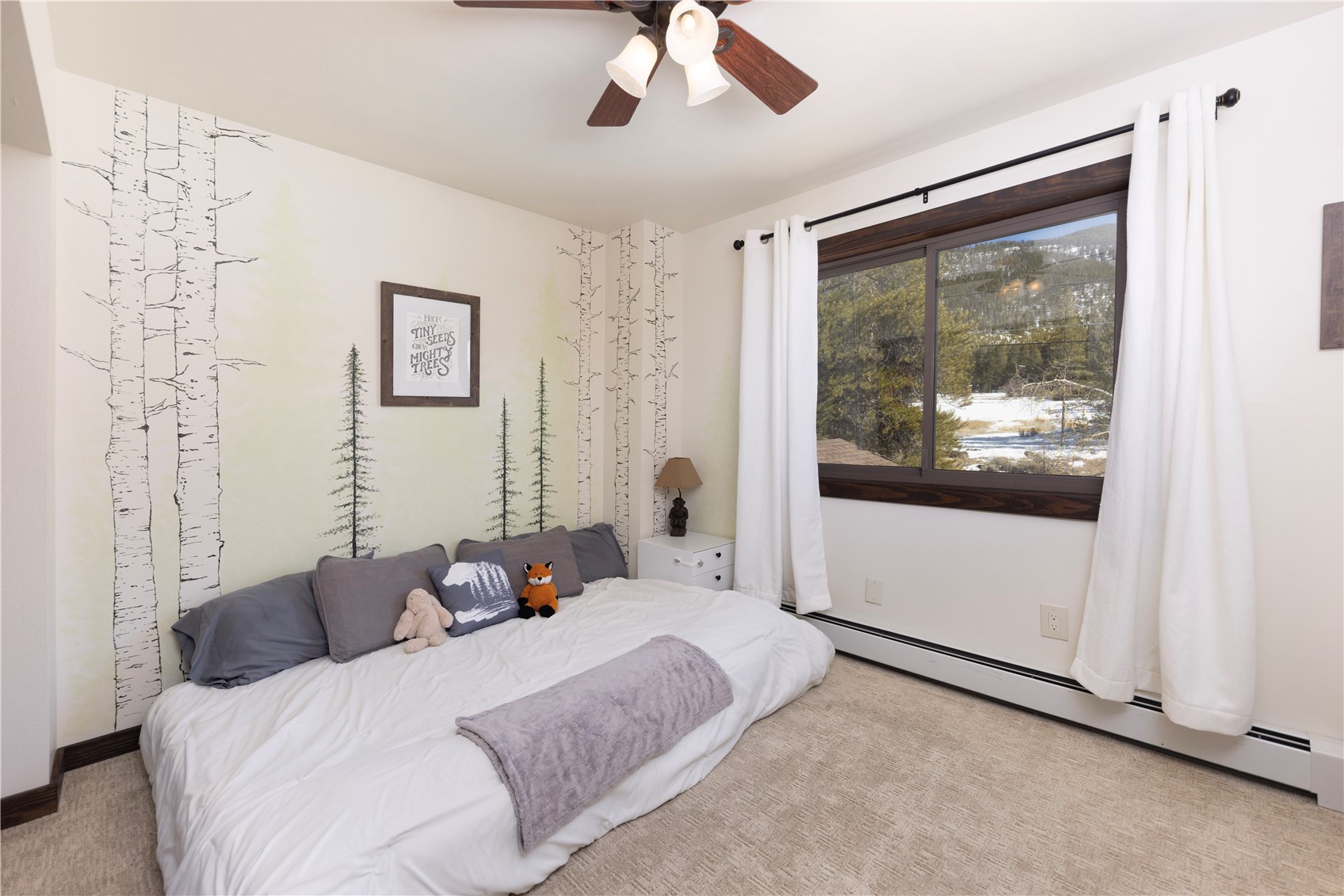 357 Vail Circle Dillon, CO 80435 - Photo 19 of 30 a bedroom with a large bed and a large window