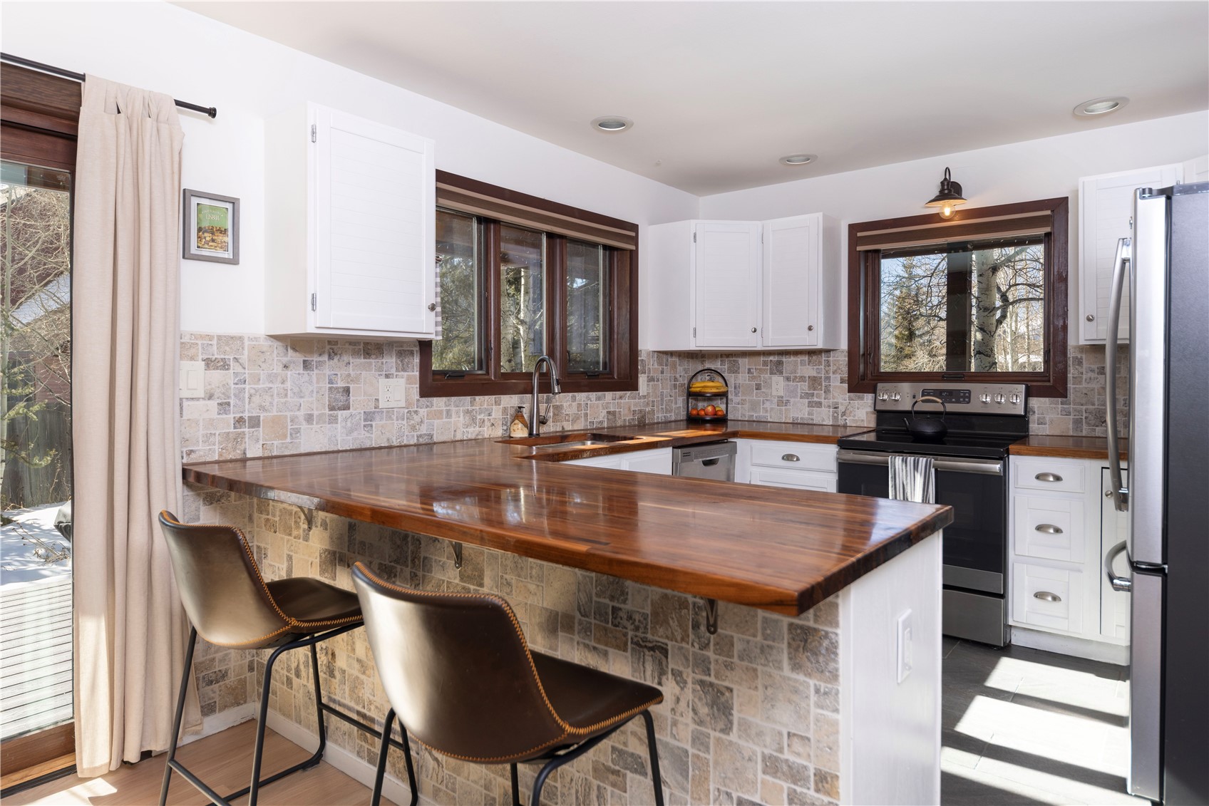 357 Vail Circle Dillon, CO 80435 - Photo 2 of 30 a kitchen with a table chairs sink and cabinets