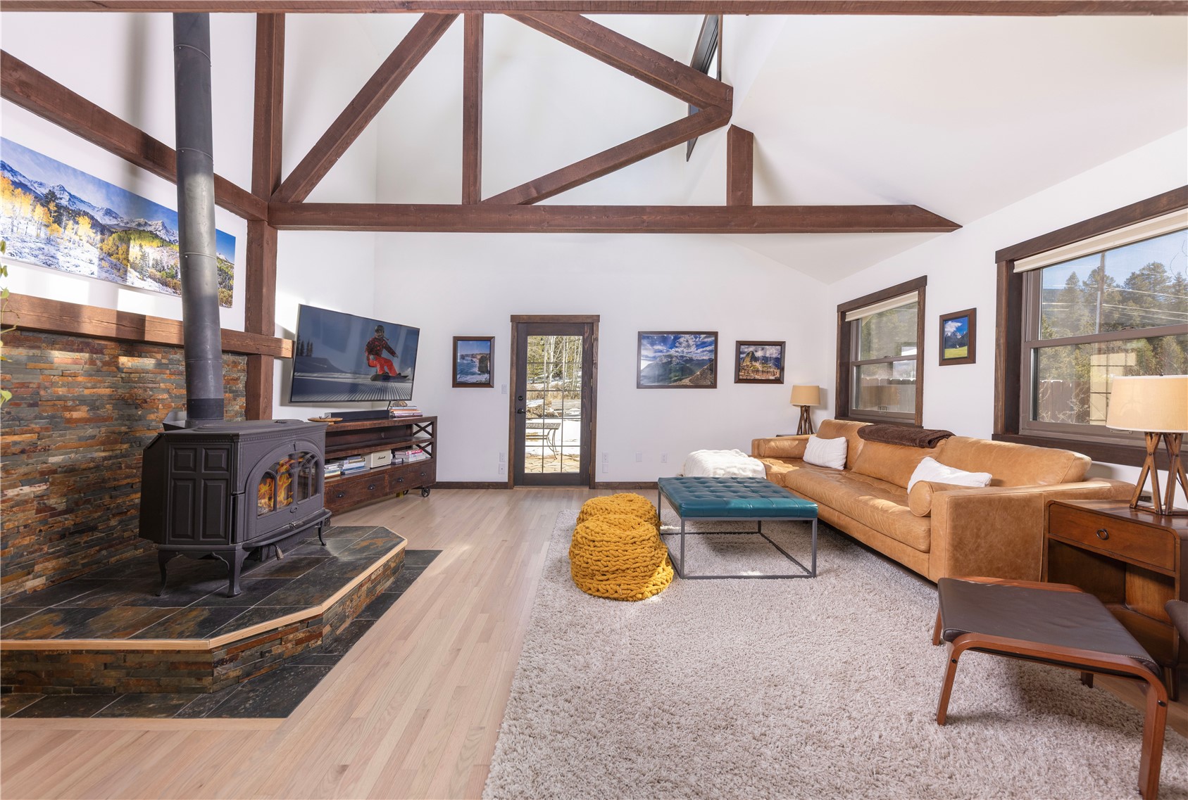 357 Vail Circle Dillon, CO 80435 - Photo 6 of 30 a living room with furniture a fireplace and a large window