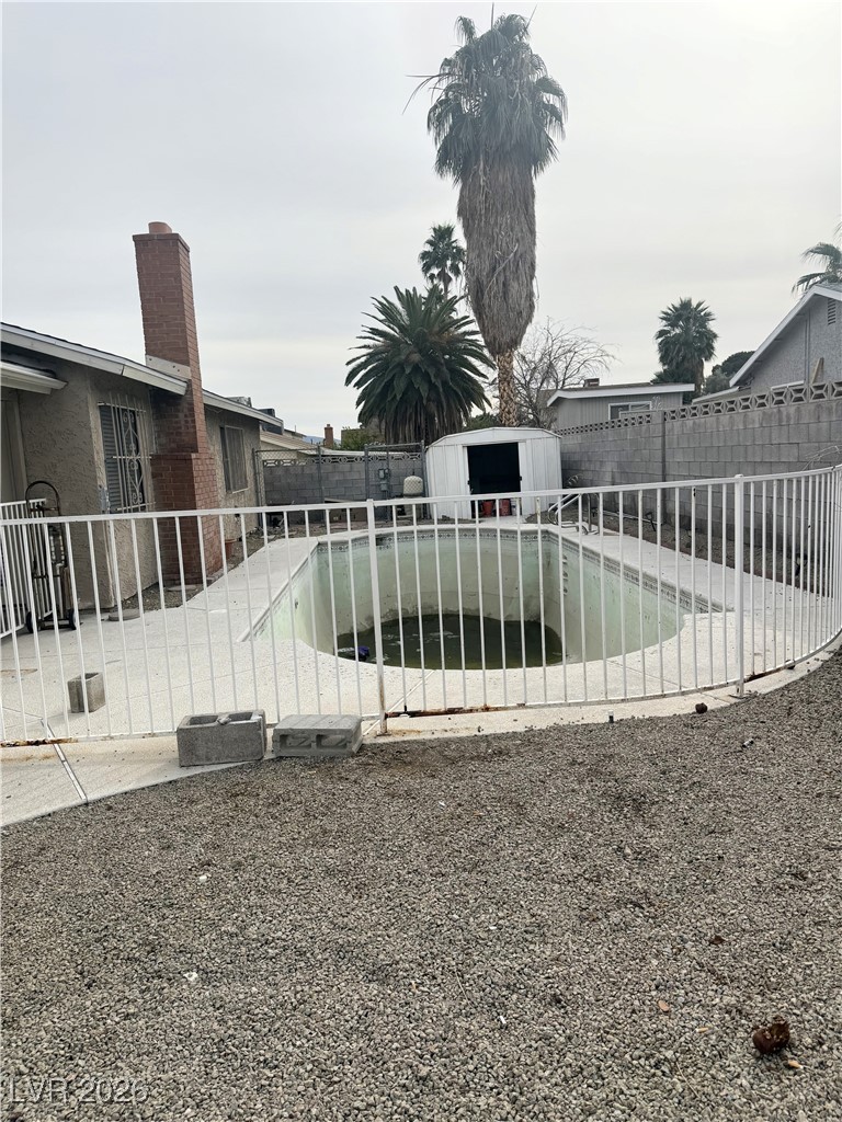 5311 South Sandhill Road Las Vegas, NV 89120 - Photo 21 of 24 View of pool with a fenced backyard and a shed