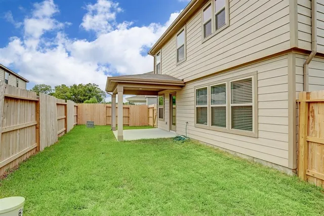 a view of an house with backyard space and garden