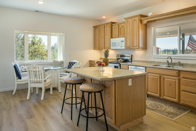 684 Blue Mountain Ridge Monticello, UT 84535 - Photo 36 of 71 Kitchen featuring white appliances, light countertops, a center island, light wood-style flooring, and recessed lighting