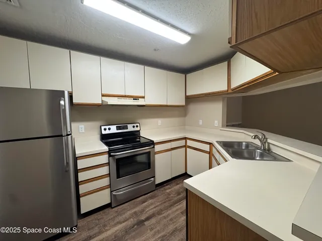 a kitchen with a sink a stove and refrigerator
