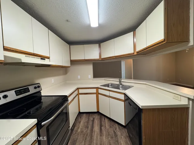 a kitchen that has a sink and a stove in it