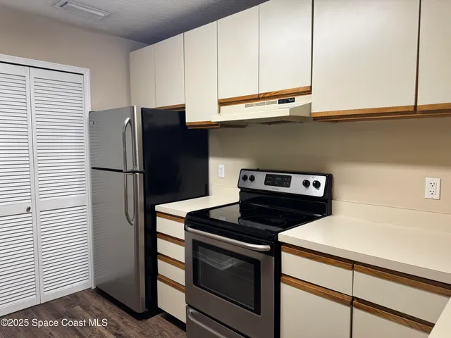 a kitchen with stainless steel appliances granite countertop a stove a refrigerator and a microwave