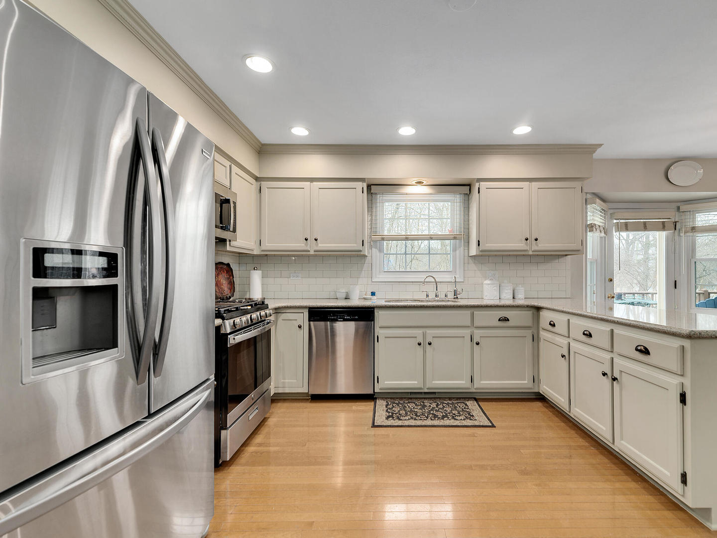 27W626 Garys Mill Road Winfield, IL 60190 - Photo 10 of 23 a kitchen with stainless steel appliances granite countertop a refrigerator sink and cabinets