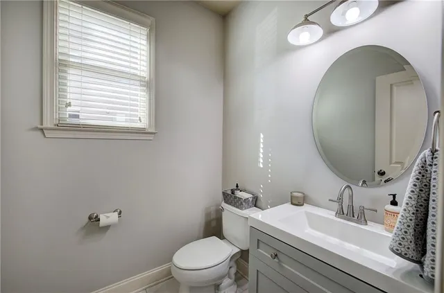 a bathroom with a toilet sink and mirror