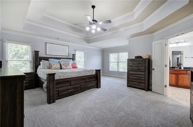 a bedroom with furniture and a chandelier
