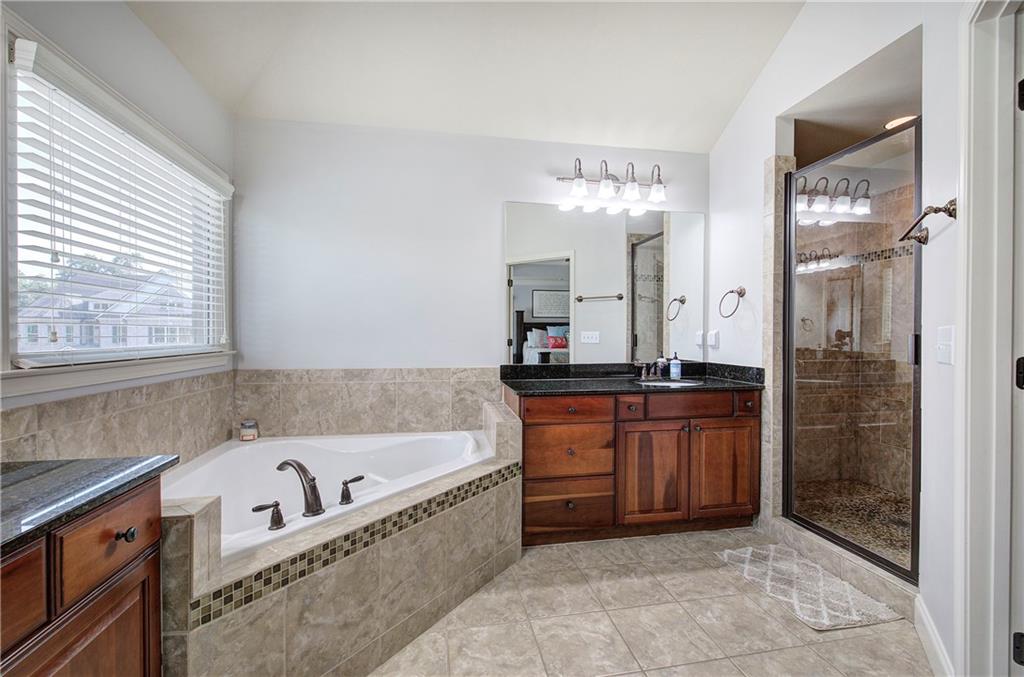12 Autumn Wood Drive Cartersville, GA 30120 - Photo 23 of 48 a bathroom with a bathtub a double vanity sink and mirror