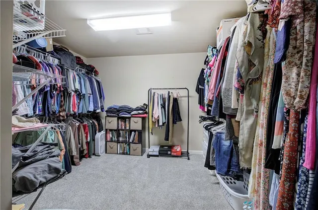 a view of walk in closet with clothes