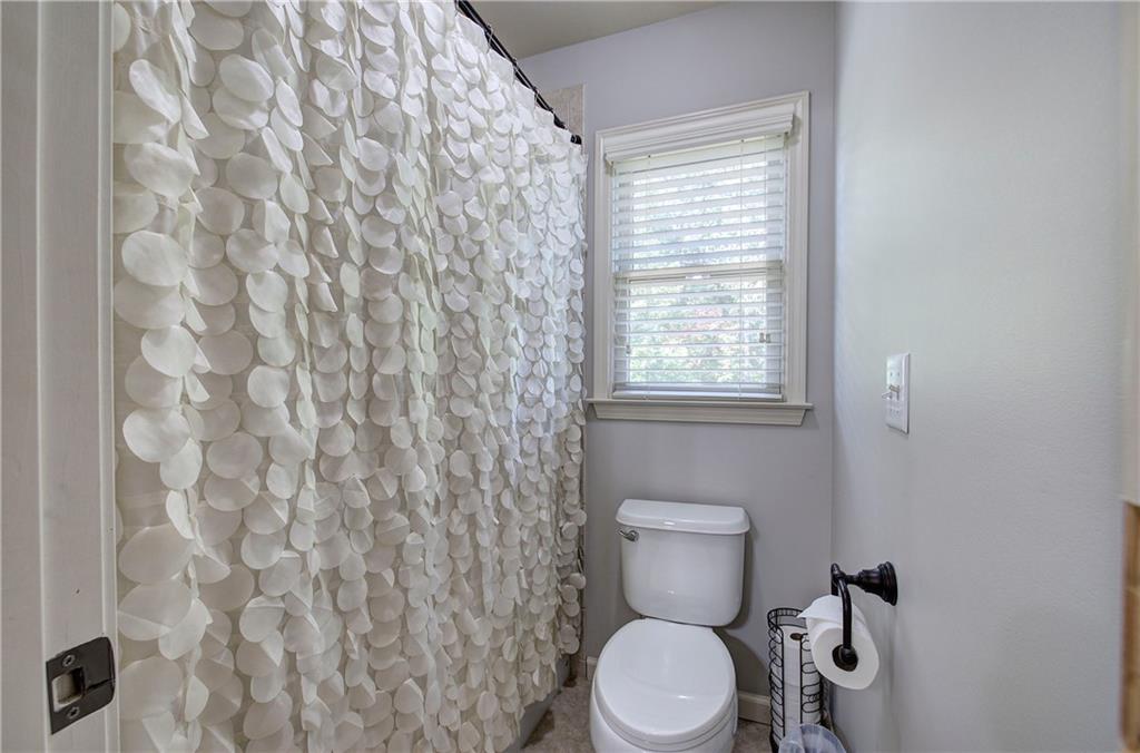 12 Autumn Wood Drive Cartersville, GA 30120 - Photo 30 of 48 a white toilet sitting next to a shower curtain