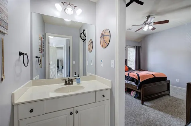 a en suite bathroom with a double vanity sink and a mirror