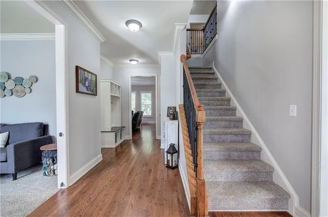 a view of entryway and hall with wooden floor