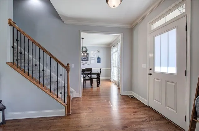 a view of dining room with wooden floor and windows