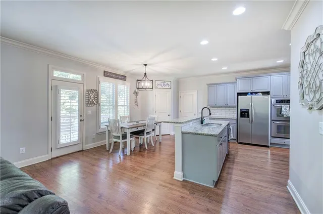a view of a dining room with furniture and wooden floor