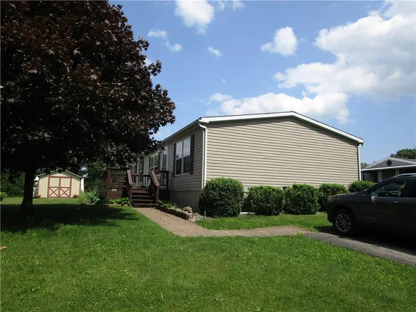 a view of a backyard with sitting area and garden
