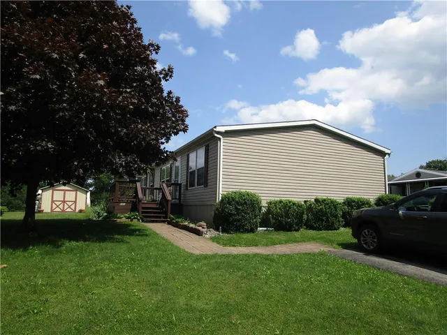 a view of a backyard with sitting area and garden