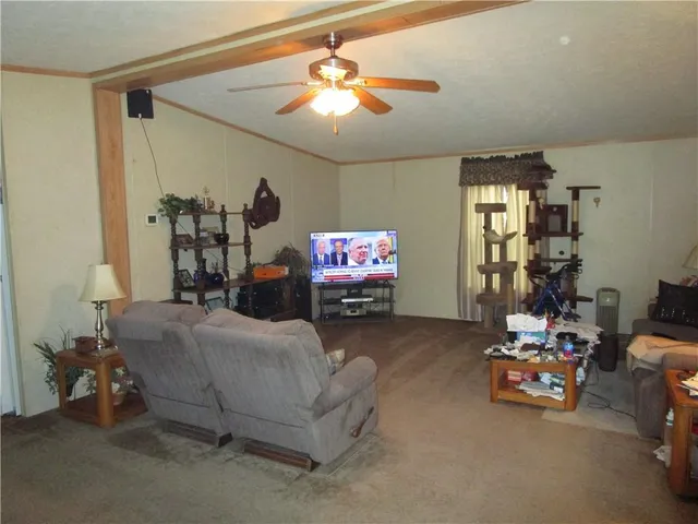 a bedroom with furniture and a flat screen tv