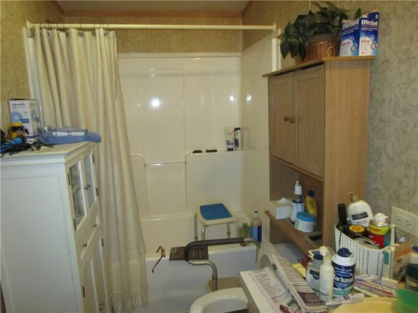 a bathroom with a sink mirror and shower