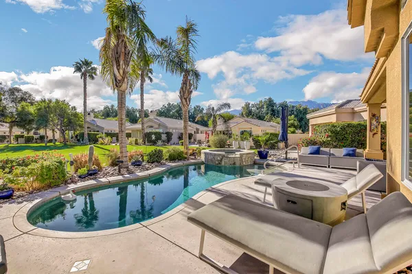 a view of a swimming pool and lounge chairs