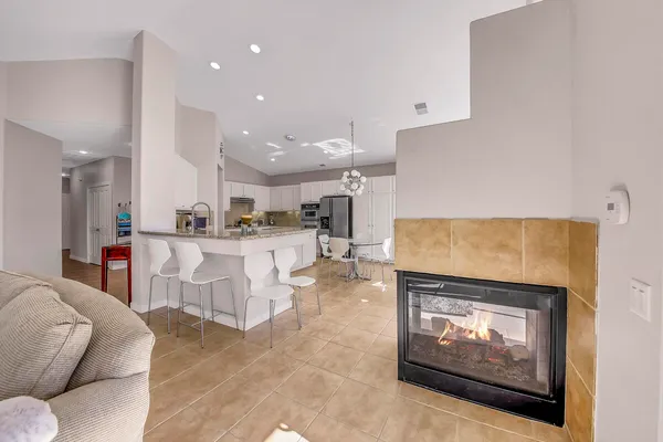 a large kitchen with a table and chairs