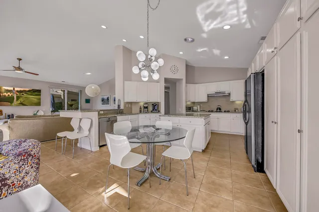 a kitchen with a sink and white cabinets