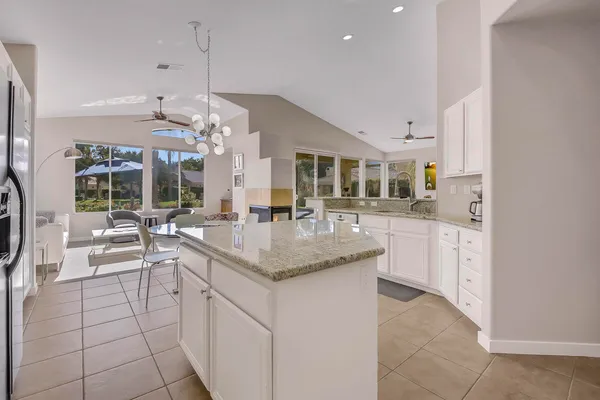 a kitchen with stainless steel appliances granite countertop a sink a stove and a refrigerator