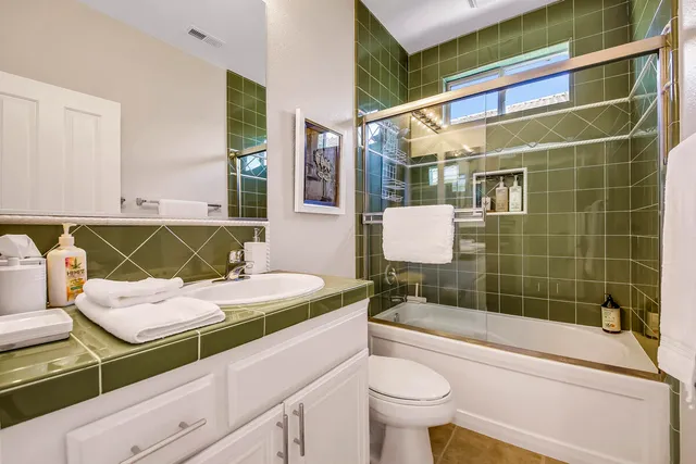 a bedroom with two beds and a window