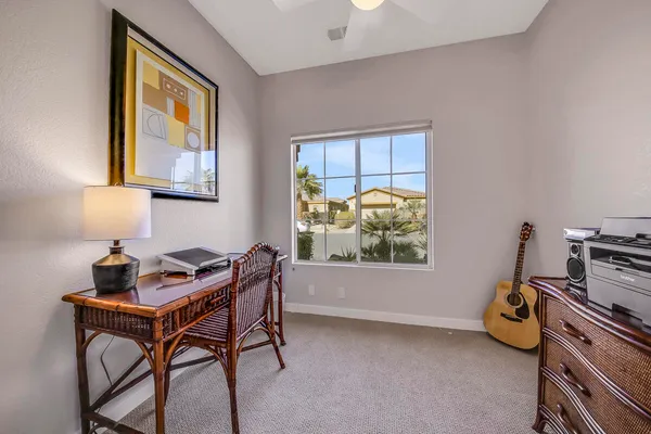 a living room with furniture and a floor to ceiling window