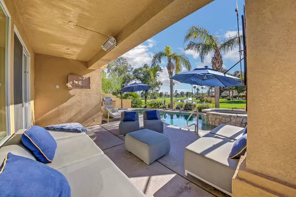 a view of a patio with couches and a table and chairs