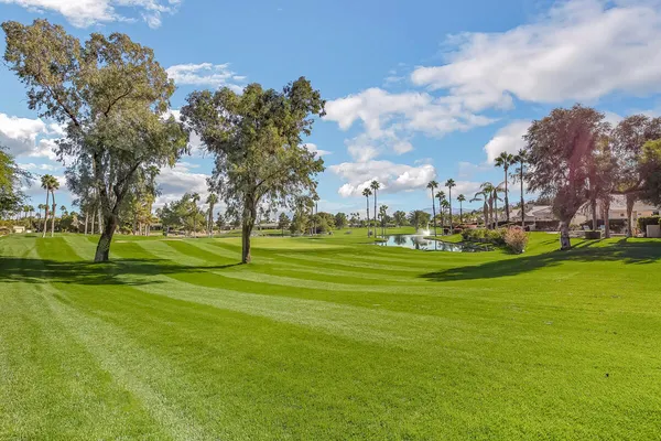 a view of pool with table and chairs under an umbrella