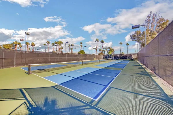 a view of a room with lots of wooden furniture and windows