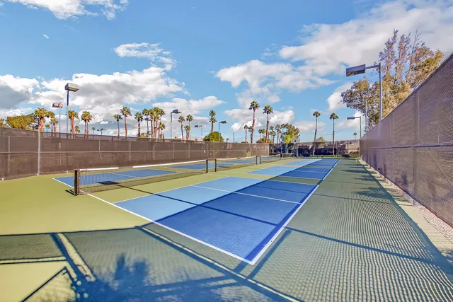 a view of a room with lots of wooden furniture and windows