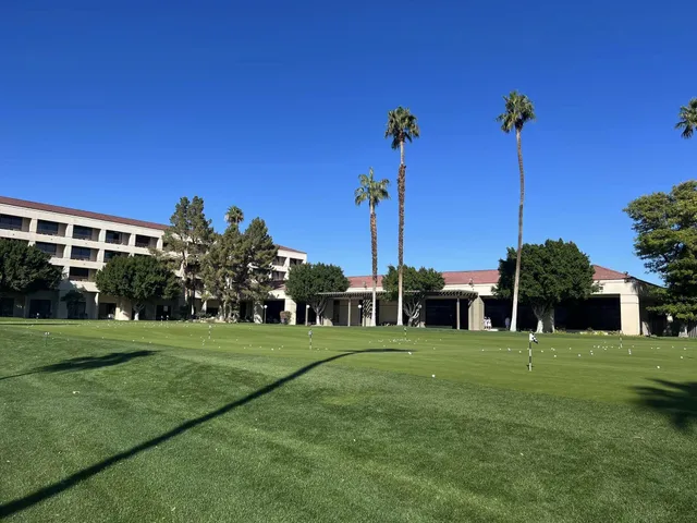 a view of a lake with a big yard and palm trees