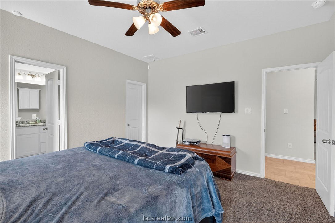 5235 Montague Loop Bryan, TX 77807 - Photo 17 of 25 a bedroom with a bed and a flat screen tv