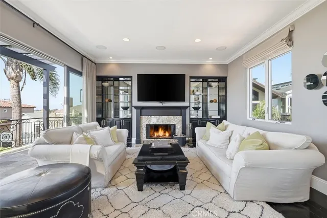 a living room with furniture a fireplace and a flat screen tv