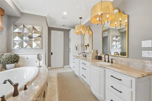 a spacious bathroom with a granite countertop sink a mirror a vanity and a bathtub
