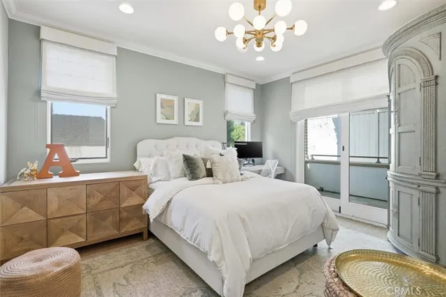 a spacious bedroom with two beds and chandelier