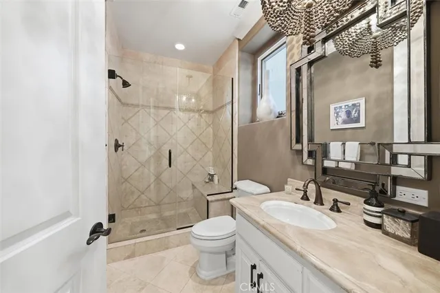 a bathroom with a granite countertop sink toilet and shower